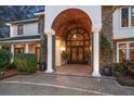 Grand entrance featuring stone columns, detailed woodwork, and custom doors at 1755 Mccauley Rd, Clearwater, FL 33765