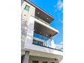 Modern balcony view with glass railings and stylish accents against a sunny sky at 211 W Columbus Dr # 1, Tampa, FL 33602