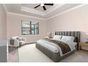 Comfortable bedroom featuring a ceiling fan, a large window, and a stylish upholstered bed frame at 2208 Landside Dr, Valrico, FL 33594