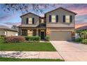 Attractive two-story home with manicured landscaping, a two-car garage, and a covered front entry at 2208 Landside Dr, Valrico, FL 33594
