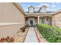 Inviting front porch featuring a stone walkway, tidy landscaping, and dormer windows above at 2240 Parrot Fish Dr, Holiday, FL 34691