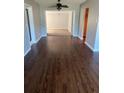 Open living room with wood floors, freshly painted walls, and a view into another living space at 2484 Roberta St, Largo, FL 33771