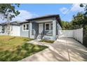 Inviting home featuring a front porch, walkway, and manicured lawn at 3405 Phillips St, Tampa, FL 33619