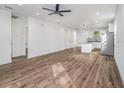 Spacious open-concept living room and kitchen, featuring wood floors at 3405 Phillips St, Tampa, FL 33619