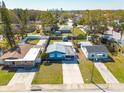 An aerial view of the cozy blue home and its well-manicured lawn and proximity to other residences at 358 51St N Ave, St Petersburg, FL 33703