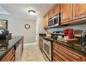 Charming kitchen features granite countertops, stainless steel appliances and wooden cabinetry at 36750 Us Highway 19 N # 19308, Palm Harbor, FL 34684