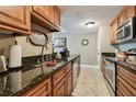 Well-maintained kitchen with granite countertops, wooden cabinetry, and stainless steel appliances at 36750 Us Highway 19 N # 19308, Palm Harbor, FL 34684