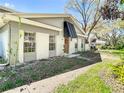Delightful home exterior with awning over the front door and beautifully framed windows, creating a warm and inviting curb appeal at 6218 Greenleaf Ln # 6218, Temple Terrace, FL 33617