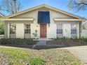 Inviting home with classic design, a welcoming front door with a wreath, and well-maintained landscaping and lawn at 6218 Greenleaf Ln # 6218, Temple Terrace, FL 33617