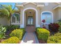 Inviting single-story home boasts of meticulous landscaping and elegant entry way at 946 Allegro Ln, Apollo Beach, FL 33572
