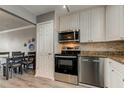 Updated kitchen with stainless steel appliances, white cabinets, and wood flooring at 10530 77Th Ter # 224, Seminole, FL 33772