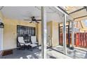 Covered patio with a ceiling fan, seating, and a view of the backyard at 12738 Wood Trail Blvd, Tampa, FL 33625