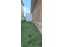 A view of the backyard with a white vinyl fence separating the two properties at 13052 Ogden Glade Rd, Dade City, FL 33525