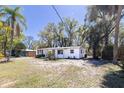 The exterior of the home shows the yard and a white exterior at 1508 W Le Compte Dr, Tampa, FL 33604