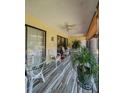 Inviting covered patio with tile flooring, ceiling fan, and relaxing seating area at 19029 Us Highway 19 N # 12E, Clearwater, FL 33764