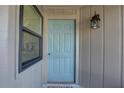 Close-up of the home's front door with decorative light fixture at 2131 Ridge S Rd # 132, Largo, FL 33778