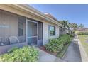 Attractive exterior featuring a screened-in porch with comfortable seating and vibrant plants at 2131 Ridge S Rd # 132, Largo, FL 33778