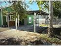 Backyard patio area with green home at 2410 Harper St, Tampa, FL 33605
