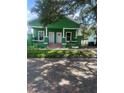 Charming green home with brick pillars and a cozy front porch at 2410 Harper St, Tampa, FL 33605