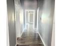 Hallway featuring hardwood flooring and white trim at 2410 Harper St, Tampa, FL 33605