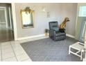 Living room with a grey area rug, mirror, recliner, and giraffe decoration at 2410 Harper St, Tampa, FL 33605