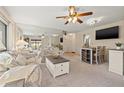Bright living room with a ceiling fan, mirror wall and neutral carpet offers a cozy spot for relaxation at 2576 Laurelwood Dr # 13C, Clearwater, FL 33763
