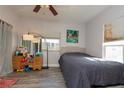 Cozy bedroom with grey wood flooring and bright natural light at 313 Jefferson S Ave, Oldsmar, FL 34677