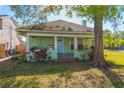Charming single-story home with a cozy porch and mature landscaping at 313 Jefferson S Ave, Oldsmar, FL 34677