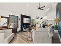 Spacious living room with an open layout, modern fireplace, and access to the kitchen, ideal for entertaining at 3327 Pineview Dr, Holiday, FL 34691