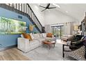 Bright living room featuring a modern sectional, high ceilings, and stylish decor at 3327 Pineview Dr, Holiday, FL 34691