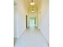 Bright hallway featuring tile flooring, recessed lighting, and an open view of the home's layout at 3444 Acacia Bay Ave, Wesley Chapel, FL 33543