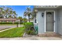 Home exterior with neat landscaping, a well-maintained entrance, and a side yard visible at 504 Cara Ct # 504, Largo, FL 33771