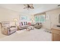Cozy living room with plush seating, ceiling fan, and natural light from the window at 5267 81St N St # 18, St Petersburg, FL 33709