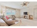 Bright living room with comfortable seating, a ceiling fan, and a TV cabinet at 5267 81St N St # 18, St Petersburg, FL 33709