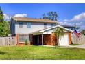 Traditional two-story home featuring a brick and siding exterior with green grass and a driveway at 531 Luzon Ave, Tampa, FL 33606