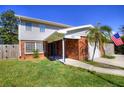 Inviting two-story home with brick accents, featuring a manicured lawn, and an American flag at 531 Luzon Ave, Tampa, FL 33606