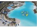 Stunning aerial view of community lagoon with water park, beach and lounge areas and multiple club houses at 7811 Roma Dune Dr, Wesley Chapel, FL 33545