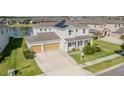 Beautiful two-story home boasts a spacious garage, a well-maintained lawn and a sunny front yard at 7811 Roma Dune Dr, Wesley Chapel, FL 33545