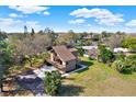Aerial view showcases the home's setting amidst lush greenery, highlighting its private location at 9222 134Th St, Seminole, FL 33776