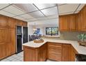 Cozy kitchen with tile backsplash, wooden cabinets, and white countertops at 9222 134Th St, Seminole, FL 33776