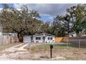 Charming single-story home with a well-maintained front yard and a secure chain-link fence at 9607 N 13Th St, Tampa, FL 33612