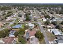 An aerial view of a suburban neighborhood featuring mature trees and well-maintained homes at 10302 Belltower St, Spring Hill, FL 34608