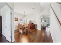 Dining room featuring hardwood floors, classic decor, and an archway leading to other rooms at 10642 Mistflower Ln, Tampa, FL 33647