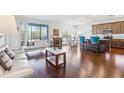 Open concept living room with hardwood floors and large windows at 10642 Mistflower Ln, Tampa, FL 33647