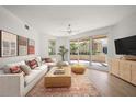 Bright living room with modern furniture, decorative rug, and sliding glass doors to the outdoor patio at 11 San Marco St # 307, Clearwater Beach, FL 33767