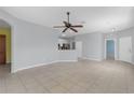 Open-concept living space with neutral paint, tile flooring, and easy access to kitchen and other rooms at 1205 Huntington Greens Dr, Sun City Center, FL 33573