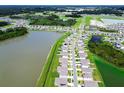 An aerial view of homes in a community neighborhood, interspersed with ponds, landscaping and green spaces at 1409 Tropical Oasis Ave, Plant City, FL 33565