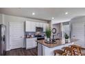 Bright kitchen with a large island, stainless steel appliances, and stylish backsplash at 17007 Barnwood Pl, Lakewood Ranch, FL 34211