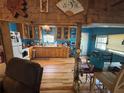 A farmhouse style kitchen with wood floors and cabinetry, blue walls, and an open concept at 17233 Dalberg Dr, Spring Hill, FL 34610