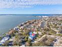 Panoramic aerial view showcasing waterfront homes, canals and the bay area with a beautiful skyline at 1956 Cedar Dr, Dunedin, FL 34698